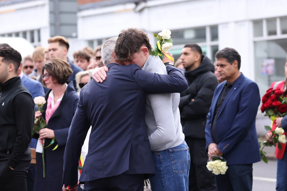 Dave held his emotional son Charlie, as he paid tribute to his brother