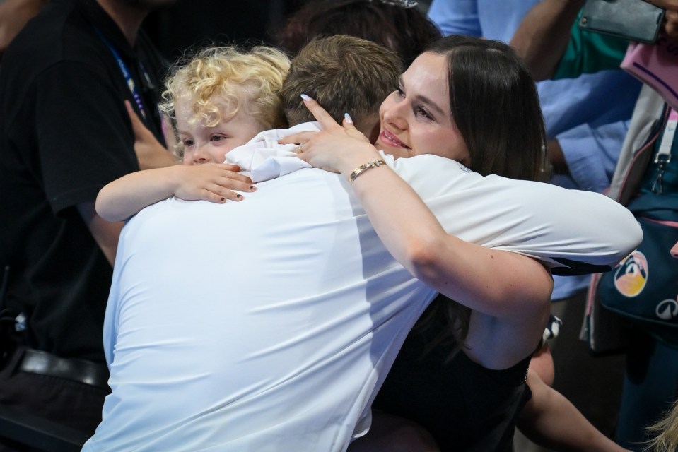 Peaty, 29, hugs girlfriend Holly and son George after last night's final