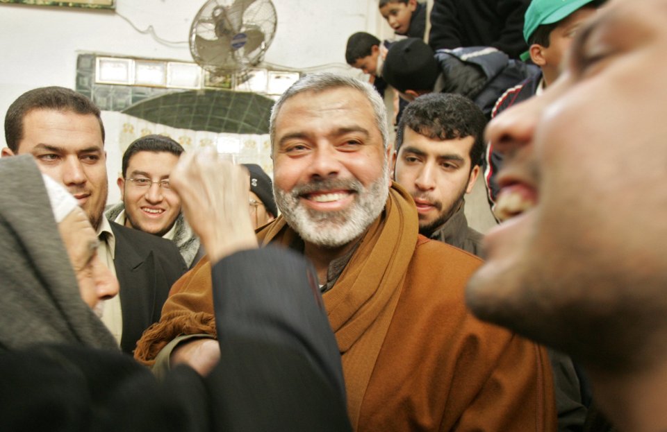 a man with a beard is smiling in a crowd of people