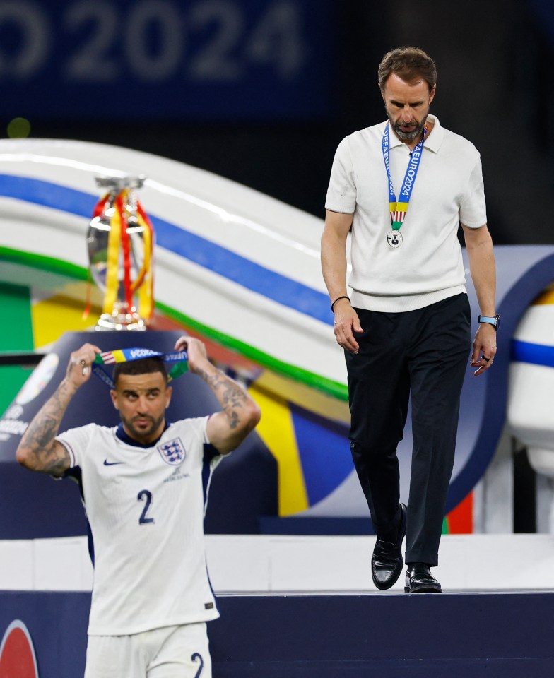Kyle Walker removed his after leaving the podium as Gareth Southgate followed suit