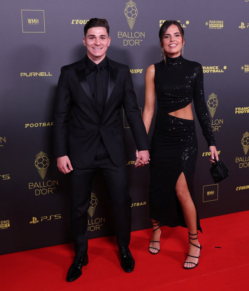 a man and woman holding hands on a red carpet that says ballon dor