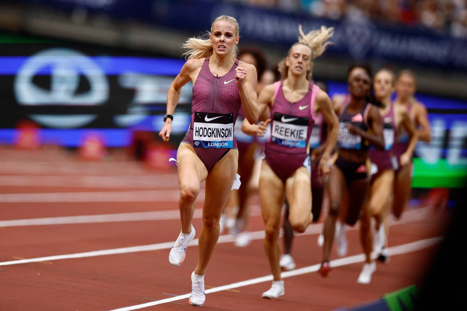 a group of women are running on a track and one of them has a name tag that says hoogkinson