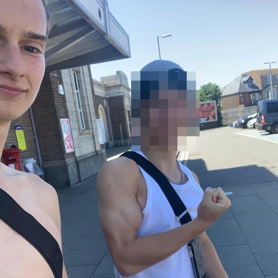 a man in a white tank top shows off his muscles