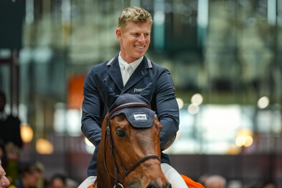 a man riding a horse with the word pixb on his jacket