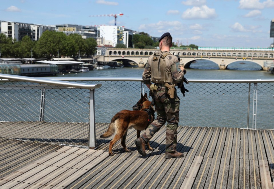 A soldier patrols on a footbridge over the Seine River, Wednesday, July 17, 2024, in Paris. (AP Photo/Aurelien Morissard)