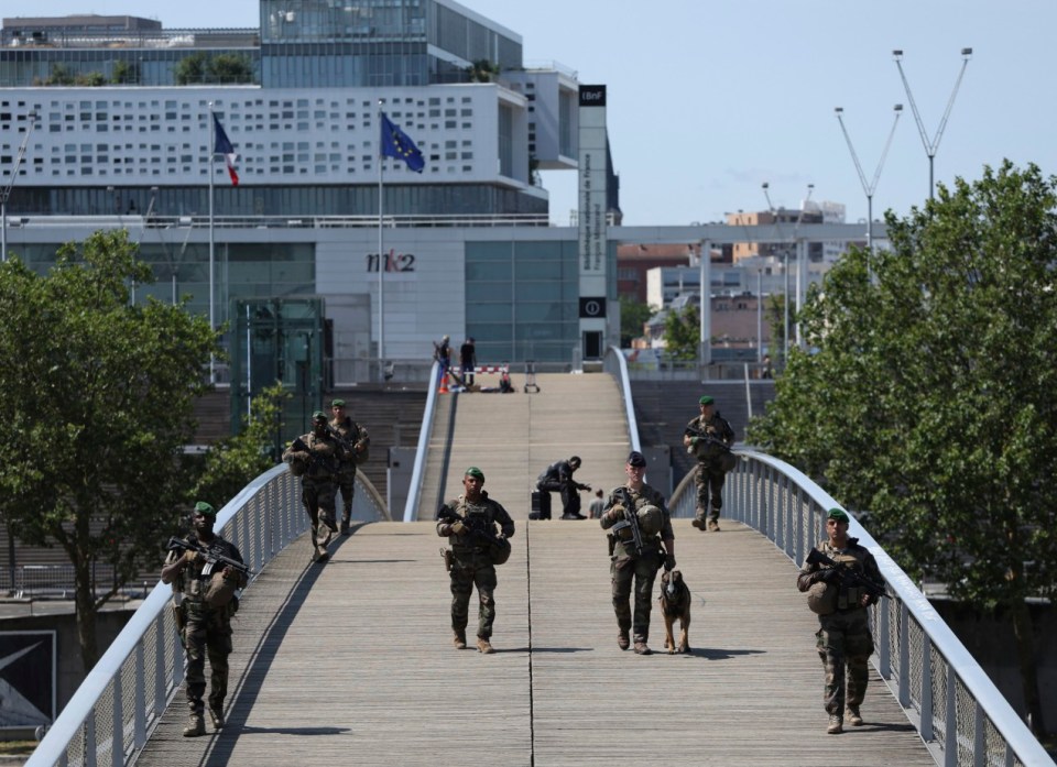 Soldiers patrol on a footbridge over the Seine River, Wednesday, July 17, 2024, in Paris. (AP Photo/Aurelien Morissard)