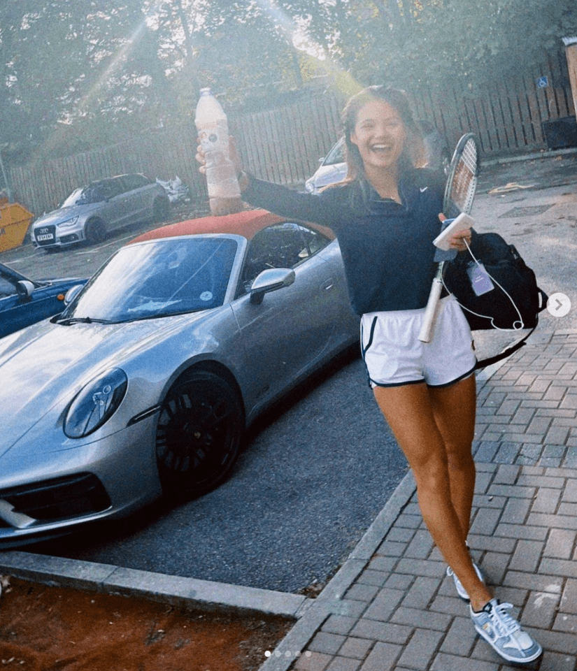 a woman holding a tennis racquet in front of a silver sports car