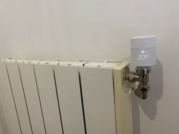 Smart thermostat attached to radiator.