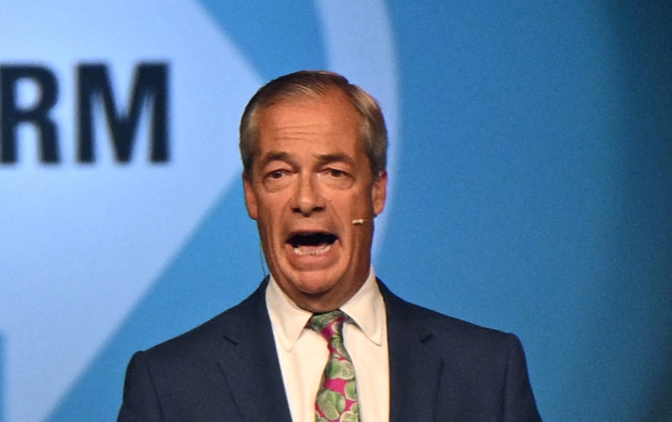 a man in a suit and tie is giving a speech in front of a sign that says rm