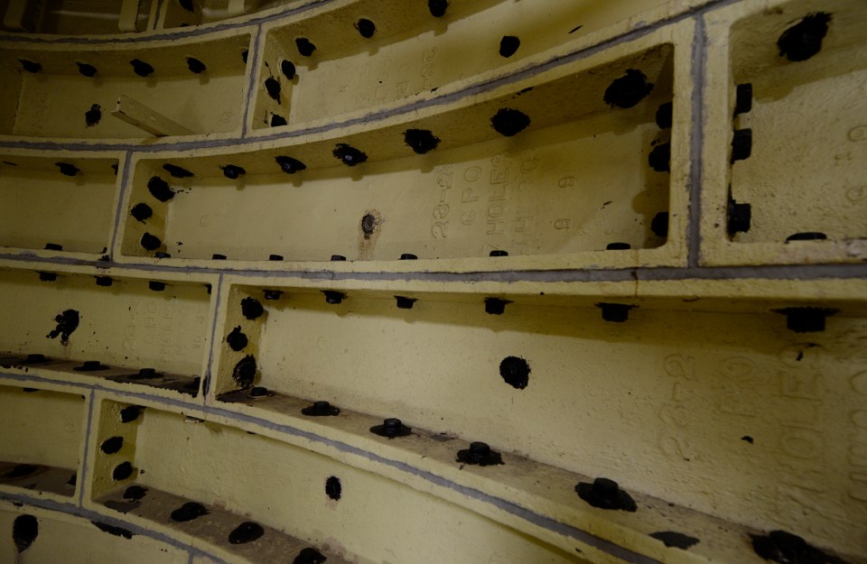 a wall with a few holes in it and a few numbers on it
