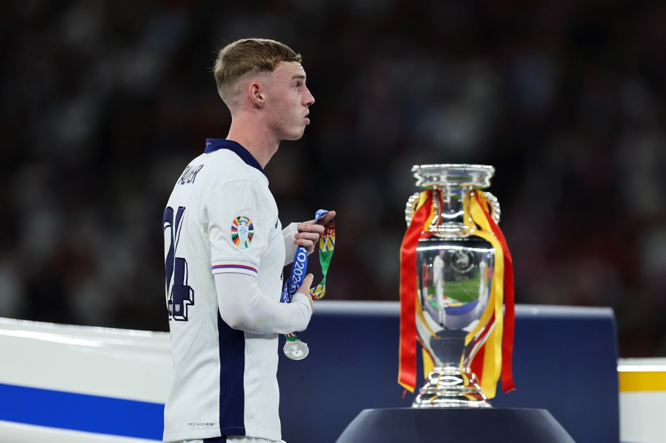 Cole Palmer removed his before he had even walked past the trophy