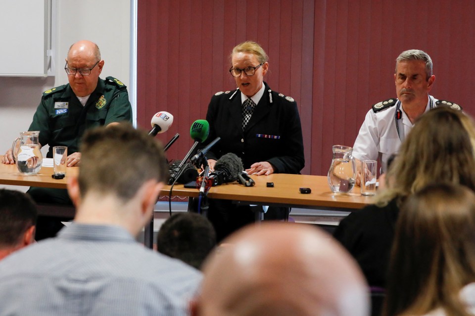 a group of people sitting at a table with microphones including one that says bbc