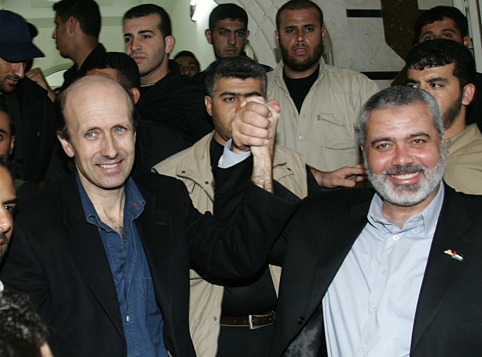 a man with a beard holds another man 's hand in a crowd