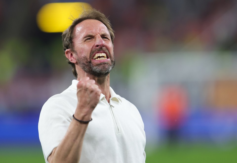 a man with his fist in the air is wearing a white shirt