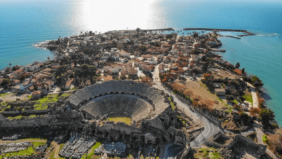 an aerial view of a city with an amphitheater in the middle