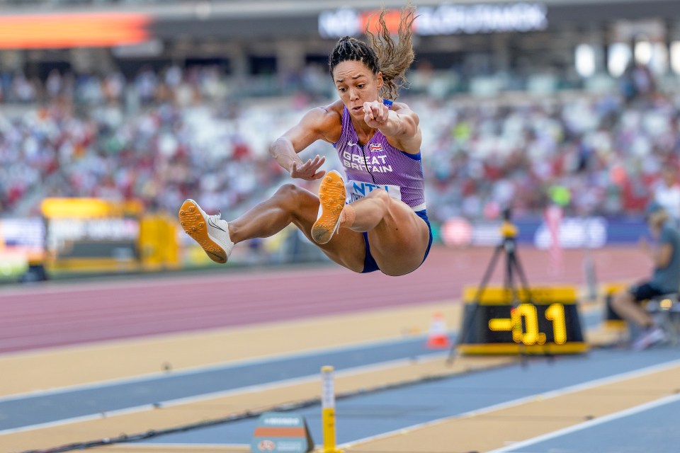 a female athlete is jumping in the air wearing a jersey that says great britain
