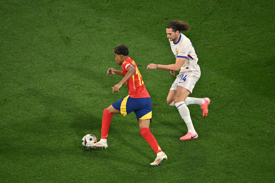 a soccer player with the number 14 on his shorts