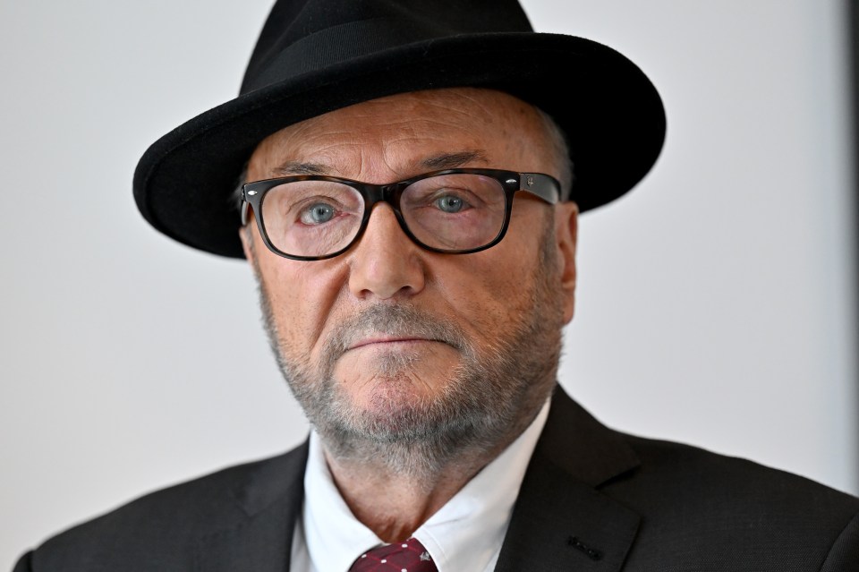 a man wearing a hat and glasses looks at the camera