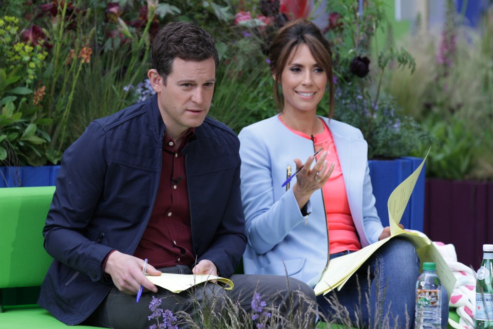 a man and a woman are sitting on a green bench