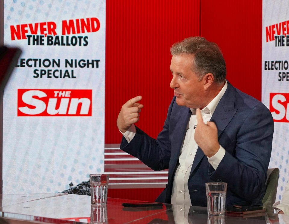 a man sits at a desk in front of a sign that says never mind the ballots