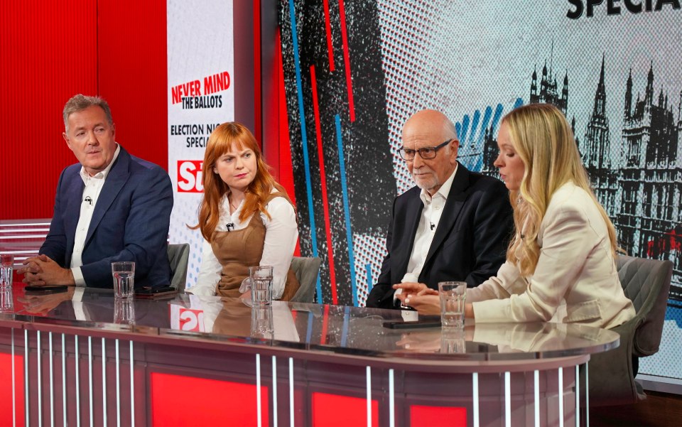 four people sit at a table with a sign that says never mind the ballots