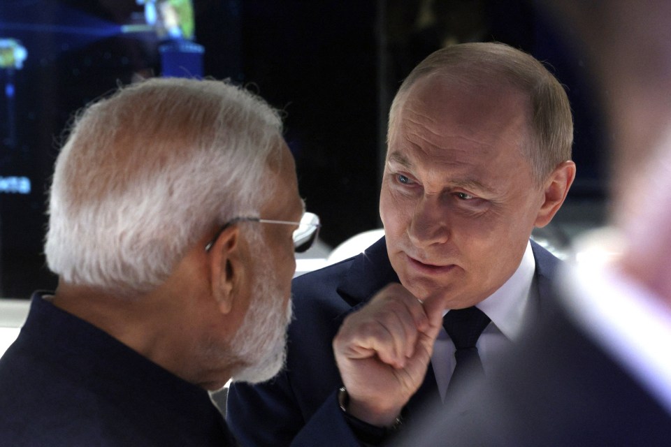 Russian President Vladimir Putin and Indian Prime Minister Narendra Modi tour the Atom pavilion at the All-Russia Exhibition Centre
