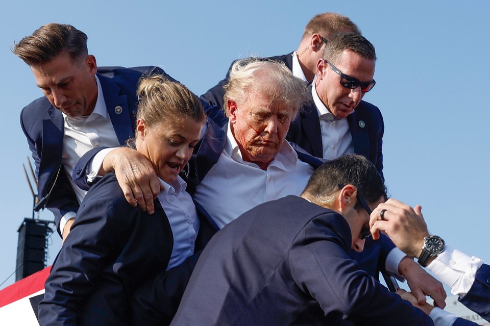 a man in a suit is being helped by a group of people