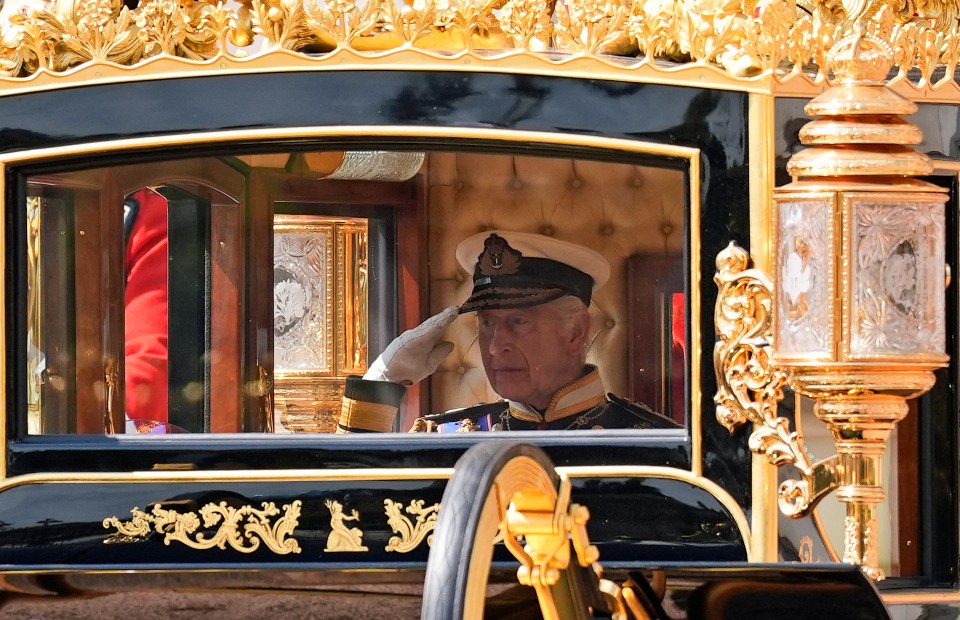 a man in a military uniform salutes while sitting in a carriage