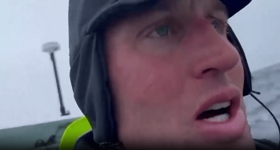 a close up of a man wearing a hat and a jacket .