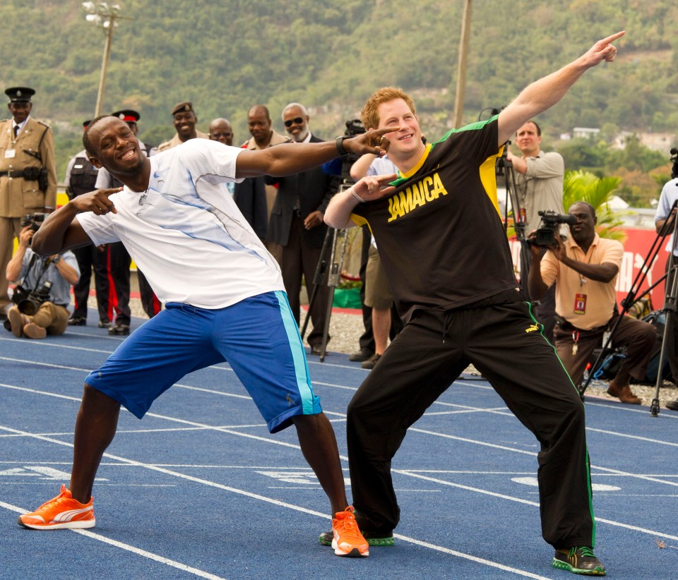 a man wearing a jamaica shirt stands next to another man