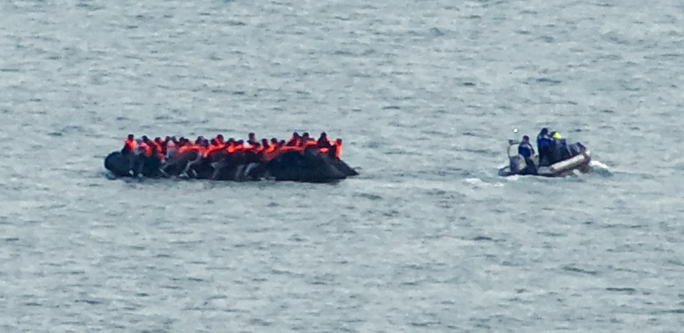 a large group of people are in a raft in the ocean