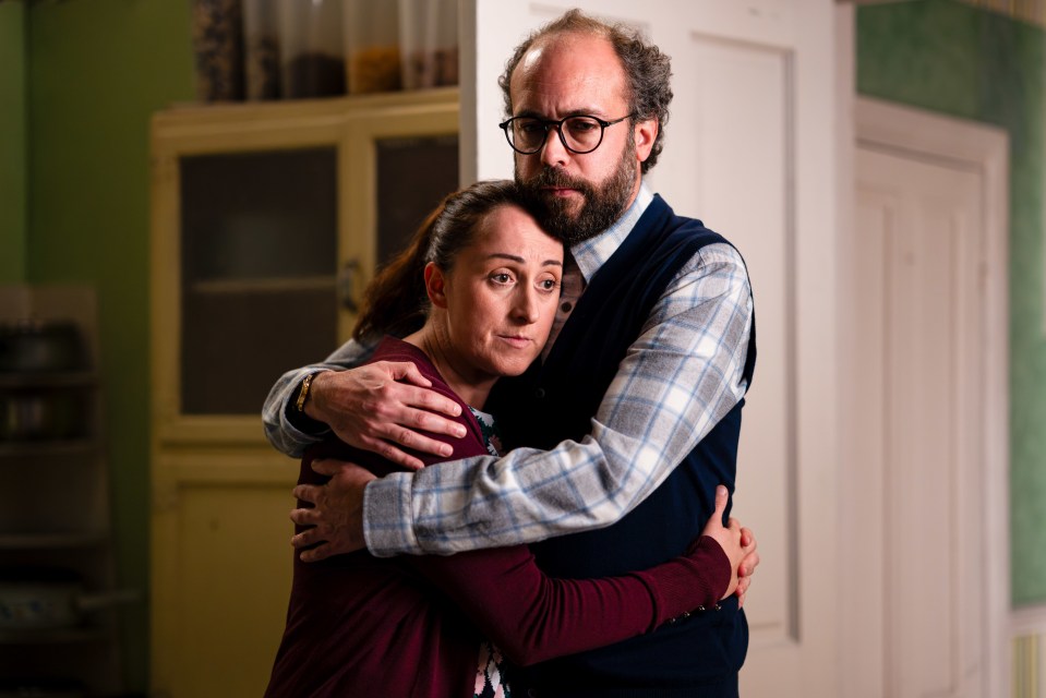 a man and a woman hugging each other in a room