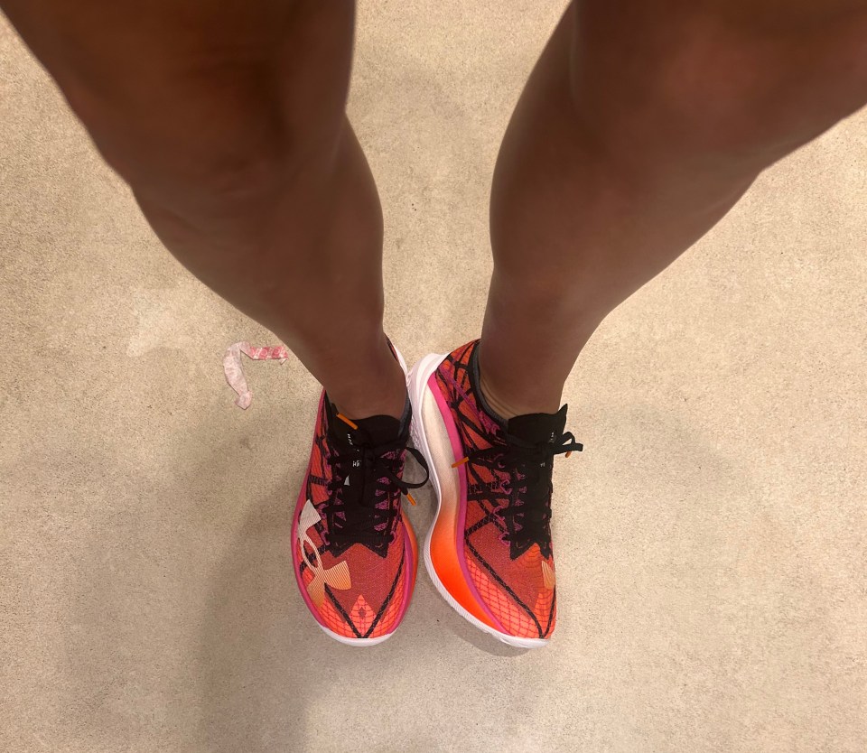a person wearing a pair of bright orange shoes