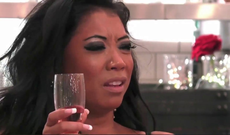 a woman with a nose ring is holding a glass of wine