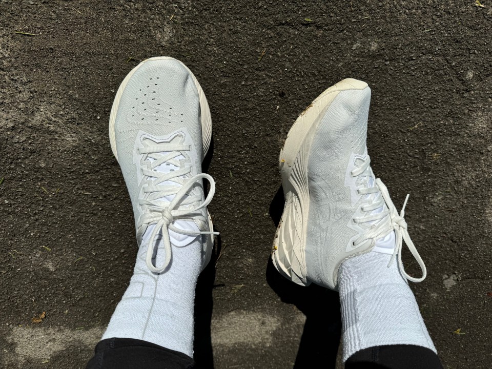 a person wearing a pair of white shoes and white socks