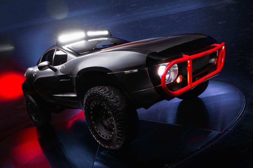 a black car with a red bumper is on display