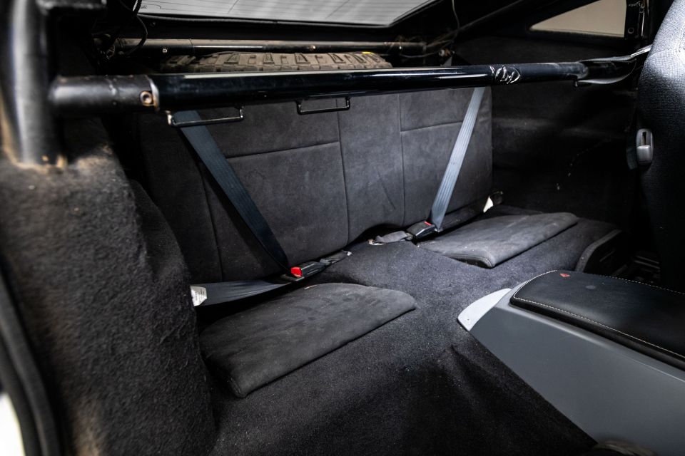 the back seat of a car has a black seat belt