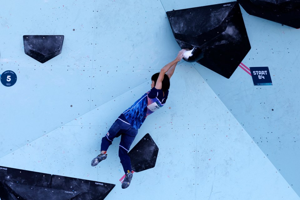 a person is climbing a wall with a sign that says start b4