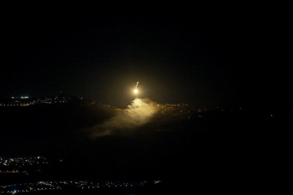 a rocket is being launched into the night sky