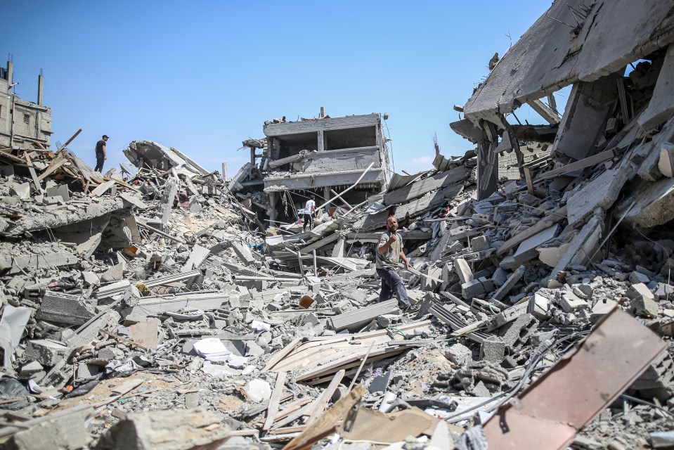 a pile of rubble with a building in the background