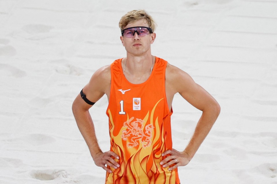 a man wearing an orange tank top with the number 1 on it
