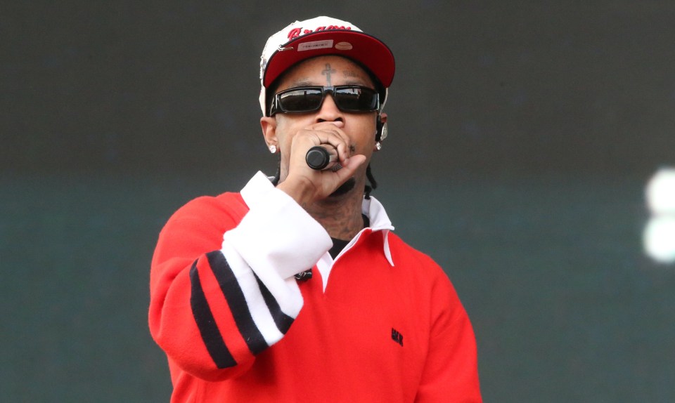 a man singing into a microphone wearing a hat that says indians