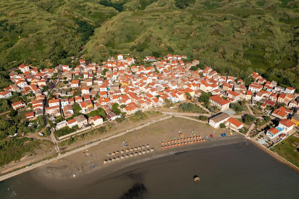 an aerial view of a small town with red roofs