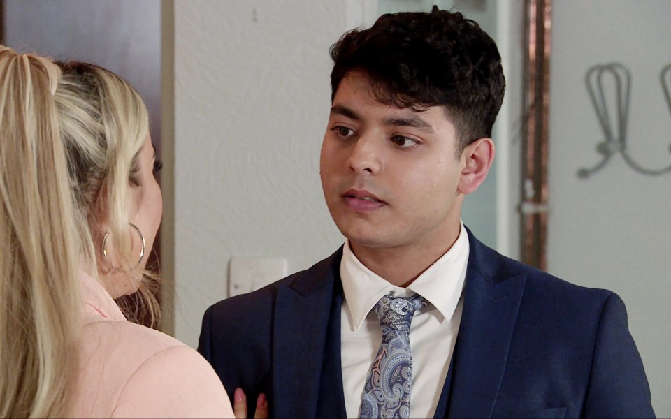 a man in a suit and tie stands next to a woman