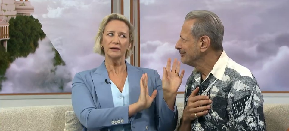 a man and a woman are sitting on a couch talking about greek gods