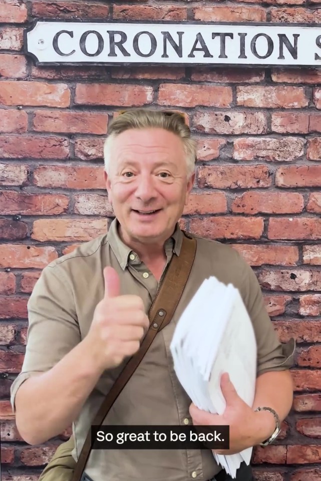 a man giving a thumbs up in front of a sign that says coronation