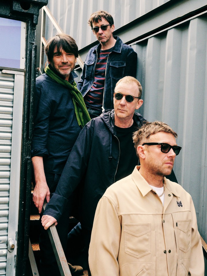 a man wearing a jacket with the letter m on it