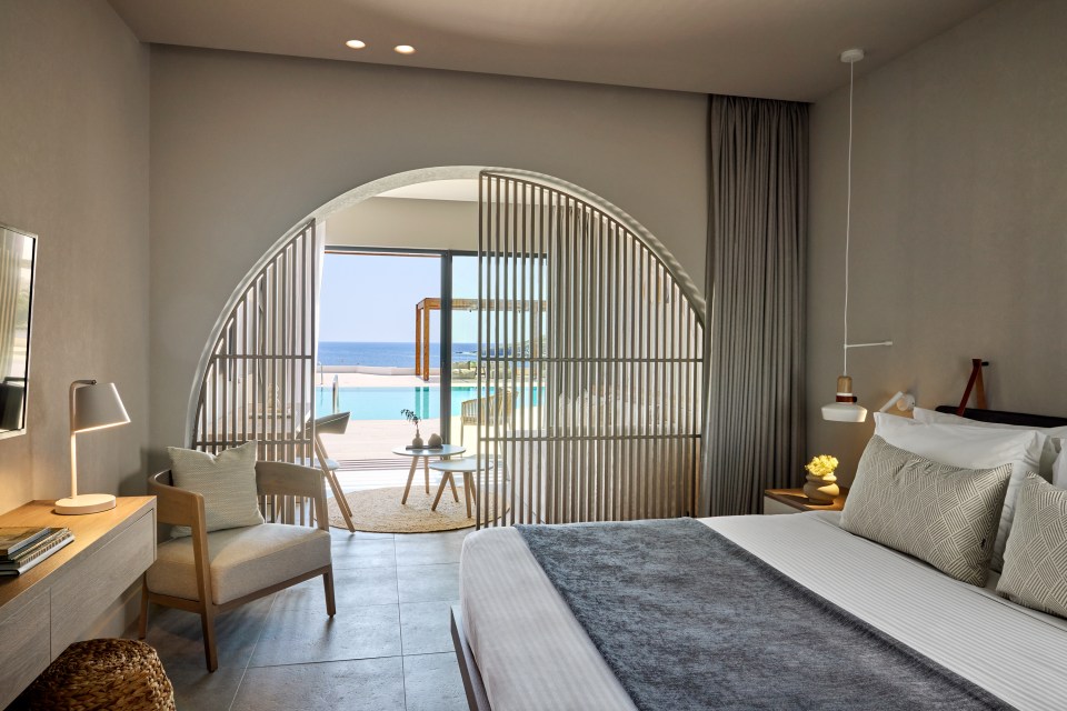 a bedroom with a sliding glass door leading to a swimming pool
