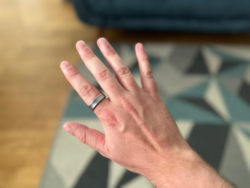 a man 's hand with a silver ring on it
