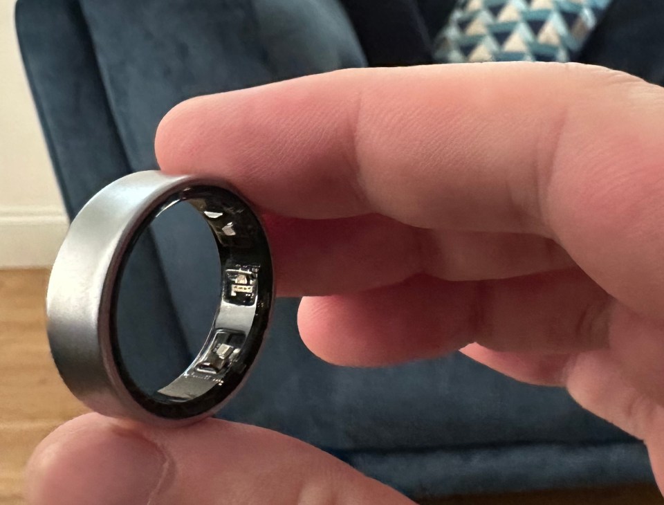 a close up of a person holding a ring that says ' i love you ' on it